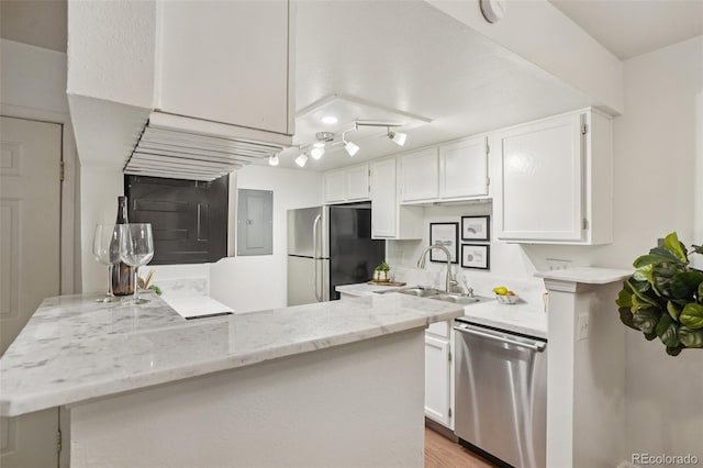 8335 Fairmount Dr Unit 5-106, Denver, CO 80247 - kitchen with stainless steel appliances, a sink, white cabinets, and light stone countertops
