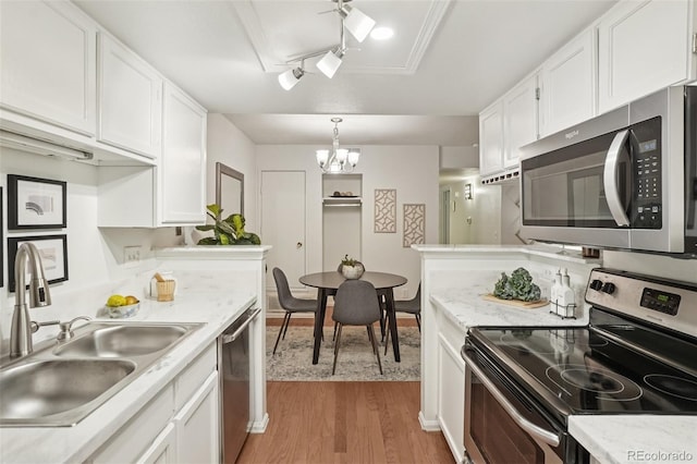 8335 Fairmount Dr Unit 5-106, Denver, CO 80247 - kitchen featuring stainless steel appliances, a sink, light wood-type flooring, white cabinets, and light countertops