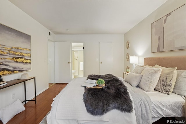 8335 Fairmount Dr Unit 5-106, Denver, CO 80247 - bedroom with wood finished floors, connected bathroom, and baseboards