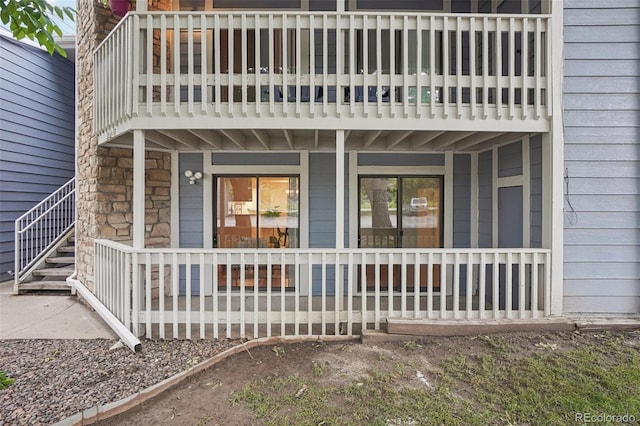 8335 Fairmount Dr Unit 5-106, Denver, CO 80247 - back of house with a balcony, a porch, and stone siding