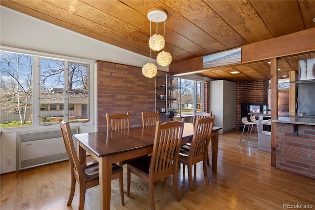 1400 E Bates Ave, Englewood, CO 80113 - dining room with wooden ceiling, wood finished floors, a fireplace, and radiator heating unit