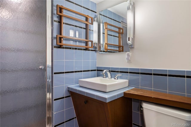 1400 E Bates Ave, Englewood, CO 80113 - full bathroom with toilet, tile walls, vanity, and a stall shower