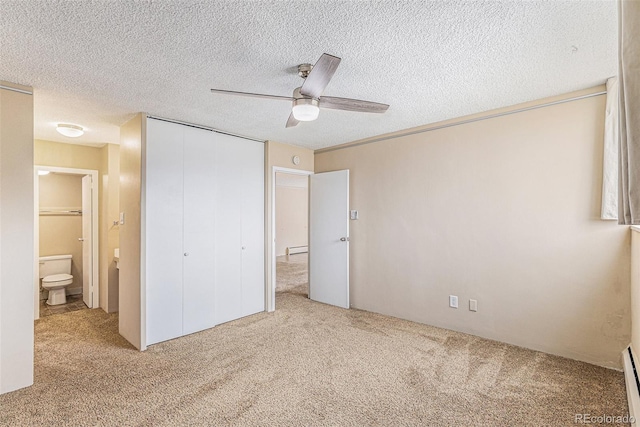 unfurnished bedroom featuring ceiling fan, a textured ceiling, and carpet