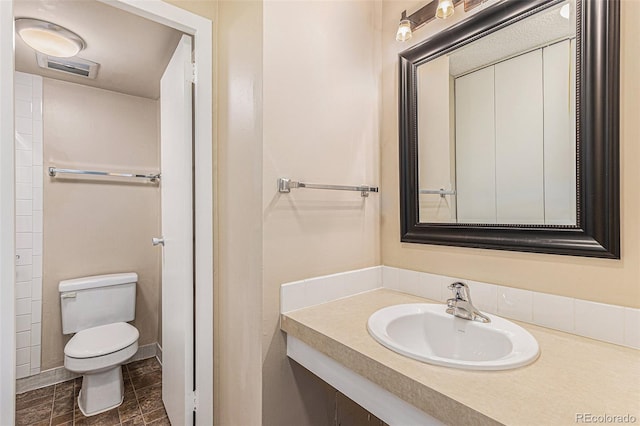 bathroom featuring vanity and toilet