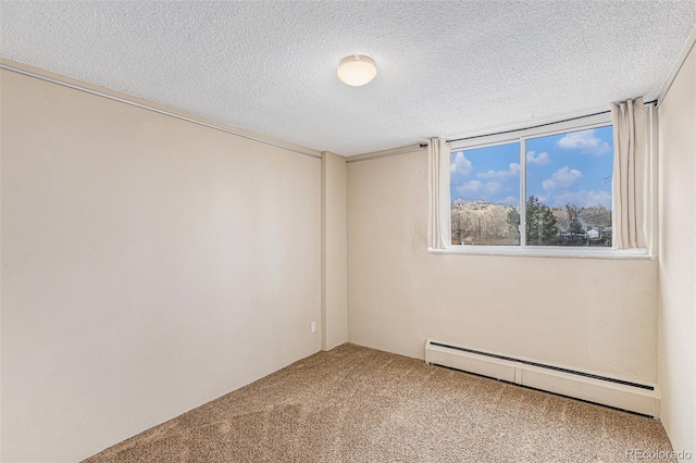 spare room featuring a textured ceiling, carpet flooring, and baseboard heating