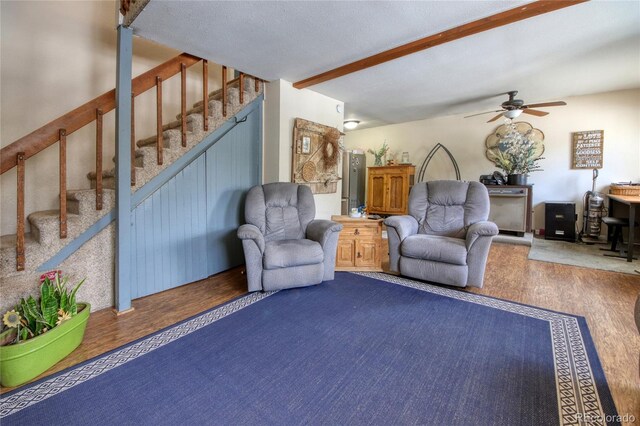 397 Will Scarlet Dr, Divide, CO 80814 - living room featuring stairway, ceiling fan, beamed ceiling, and wood finished floors
