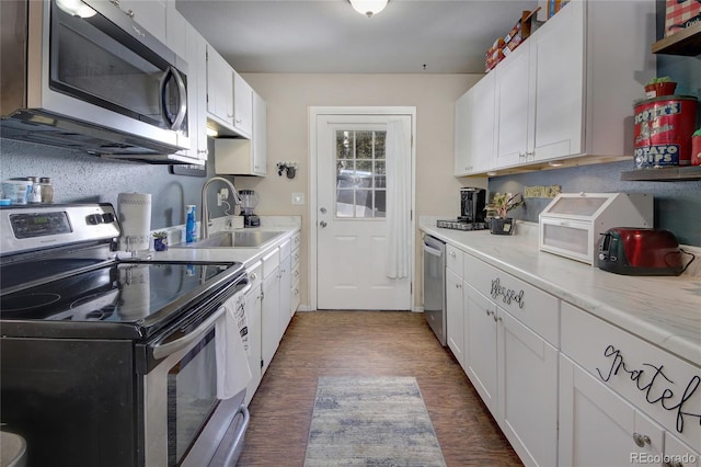 397 Will Scarlet Dr, Divide, CO 80814 - kitchen with appliances with stainless steel finishes, a sink, white cabinets, and light countertops