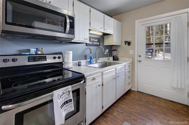 397 Will Scarlet Dr, Divide, CO 80814 - kitchen with appliances with stainless steel finishes, a sink, light countertops, white cabinets, and dark wood-style floors