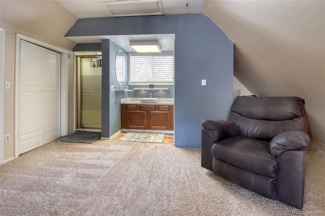 397 Will Scarlet Dr, Divide, CO 80814 - living area with lofted ceiling, light carpet, attic access, and baseboards