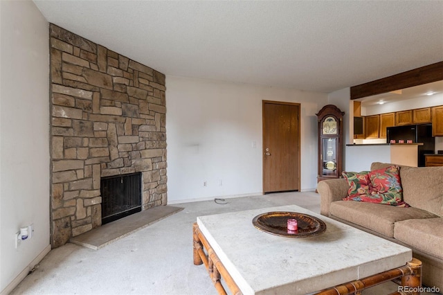 living room featuring a textured ceiling, a stone fireplace, and light carpet