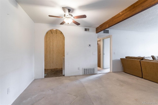 empty room with beam ceiling, ceiling fan, and light colored carpet