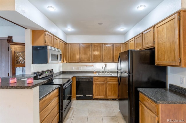 kitchen featuring black appliances, kitchen peninsula, sink, and light tile patterned floors