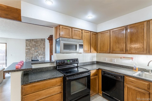 kitchen featuring kitchen peninsula, sink, and black appliances