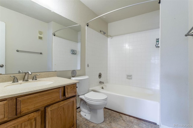 full bathroom featuring tiled shower / bath, vanity, and toilet