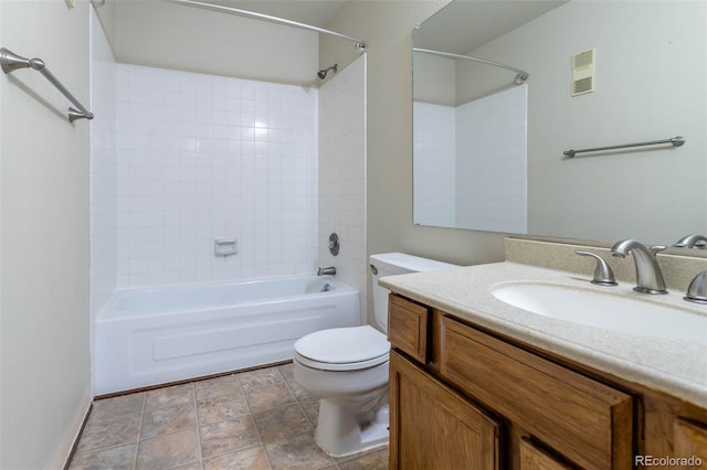 full bathroom with vanity, tiled shower / bath combo, and toilet