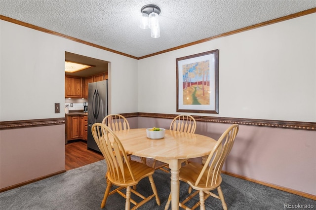 10520 W Jewell Ave Unit 102, Lakewood, CO 80232 - dining room with dark colored carpet, a textured ceiling, and crown molding