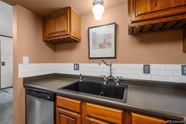 10520 W Jewell Ave Unit 102, Lakewood, CO 80232 - kitchen with brown cabinets, stainless steel dishwasher, dark countertops, and a sink