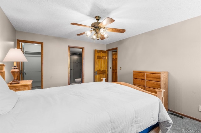 10520 W Jewell Ave Unit 102, Lakewood, CO 80232 - carpeted bedroom with visible vents, a ceiling fan, ensuite bath, baseboards, and a textured ceiling