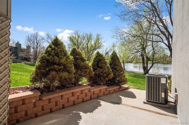 10520 W Jewell Ave Unit 102, Lakewood, CO 80232 - view of patio / terrace with cooling unit and a water view