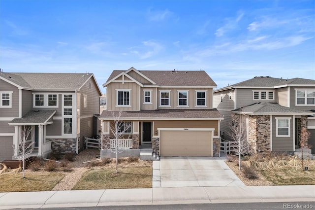 view of front facade with an attached garage, a shingled roof, concrete driveway, stone siding, and board and batten siding