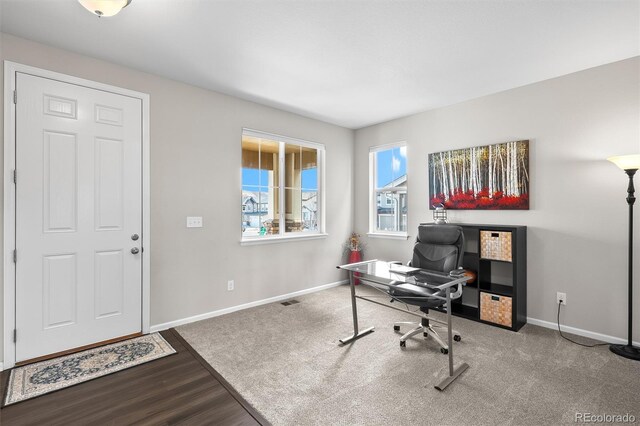 home office with visible vents, baseboards, and wood finished floors