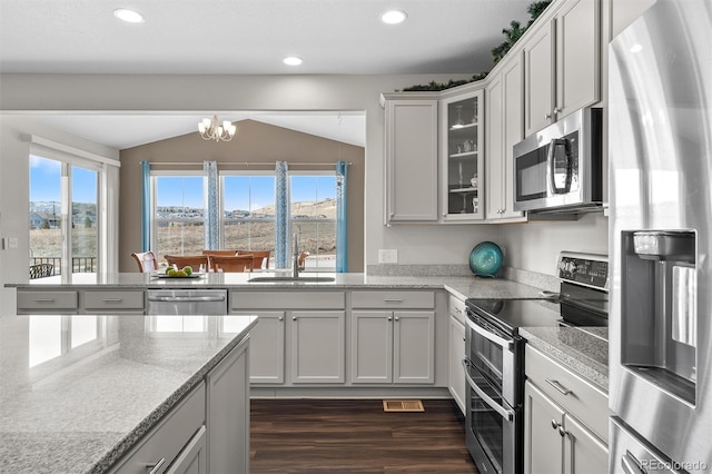 kitchen with dark wood finished floors, plenty of natural light, stainless steel appliances, and a sink