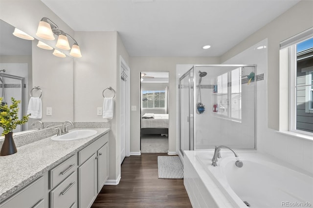 full bath featuring vanity, a shower stall, wood finished floors, and a healthy amount of sunlight