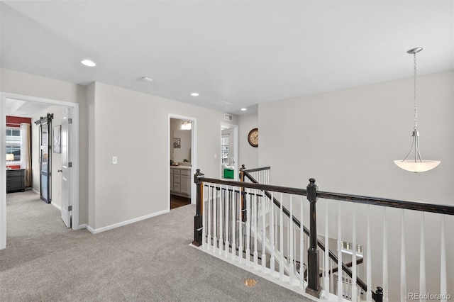 hallway featuring recessed lighting, baseboards, an upstairs landing, and carpet floors