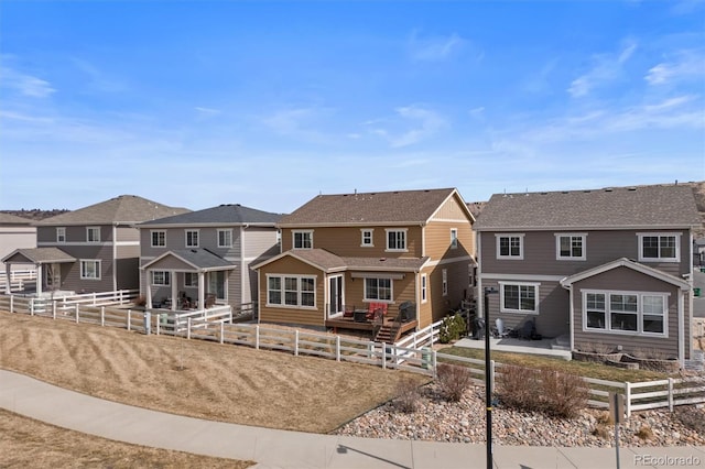 view of front facade with a residential view, a patio, and fence private yard