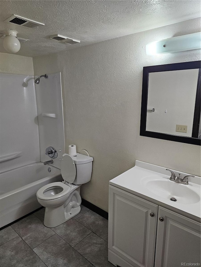 full bath with toilet, vanity, a textured ceiling, washtub / shower combination, and tile patterned floors