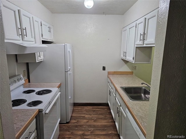 kitchen featuring white appliances, a sink, dark wood-style floors, exhaust hood, and white cabinetry