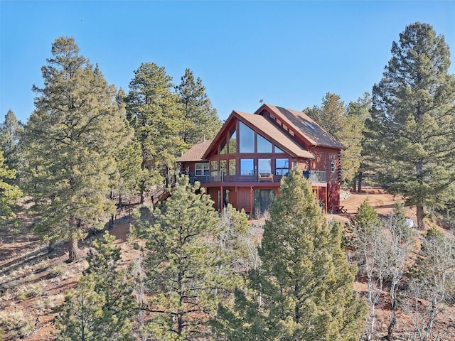 102 Douglas Fir Ln, Woodland Park, CO 80863 - rear view of property with a forest view and a deck