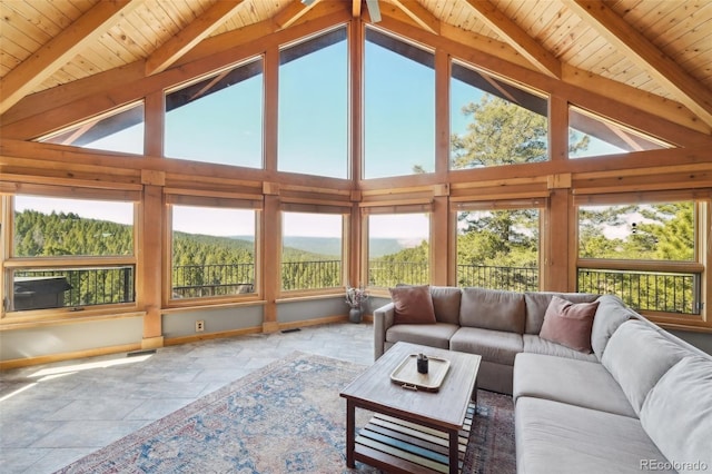 102 Douglas Fir Ln, Woodland Park, CO 80863 - living room featuring lofted ceiling with beams, baseboards, wooden ceiling, and stone tile flooring
