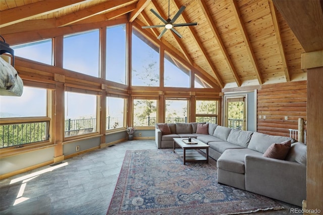 102 Douglas Fir Ln, Woodland Park, CO 80863 - living room featuring beam ceiling, a ceiling fan, stone finish flooring, wooden ceiling, and high vaulted ceiling