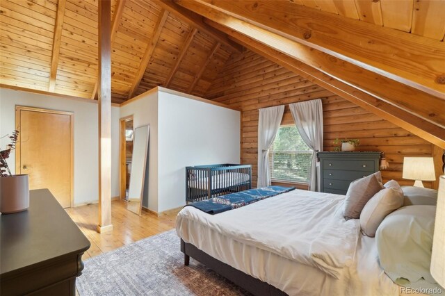 102 Douglas Fir Ln, Woodland Park, CO 80863 - bedroom featuring high vaulted ceiling, light wood-type flooring, wood ceiling, beamed ceiling, and log walls