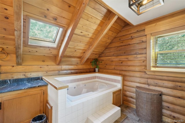 102 Douglas Fir Ln, Woodland Park, CO 80863 - bathroom with rustic walls, vanity, a bath, lofted ceiling with skylight, and wood ceiling
