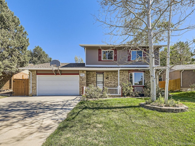 view of property with a garage, covered porch, and a front yard