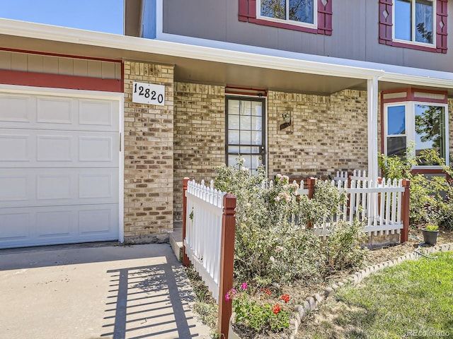 property entrance with a garage and a porch