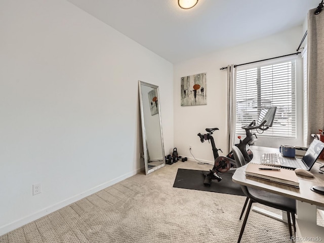 exercise area featuring lofted ceiling and light carpet