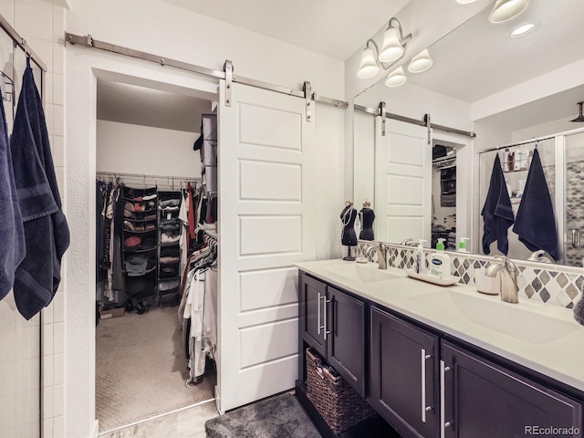 bathroom featuring walk in shower and vanity