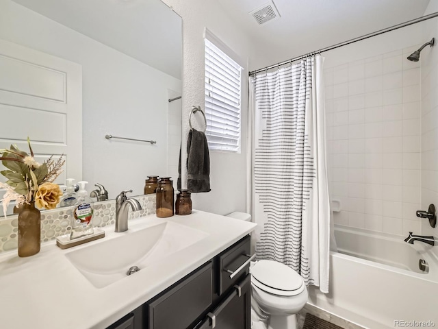 full bathroom with vanity, toilet, and shower / bath combo with shower curtain