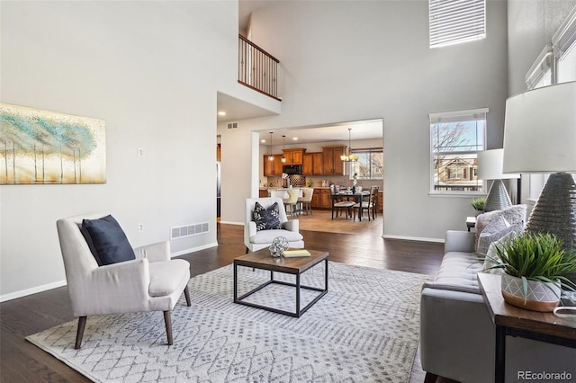 living room with dark hardwood / wood-style flooring and a high ceiling