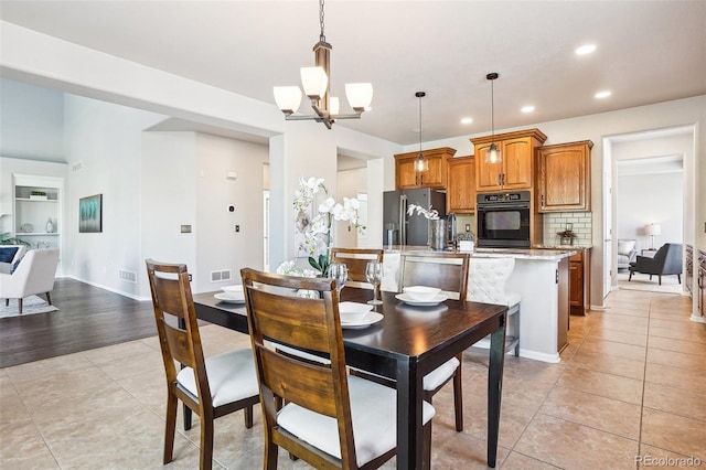 dining area featuring an inviting chandelier and light tile patterned flooring