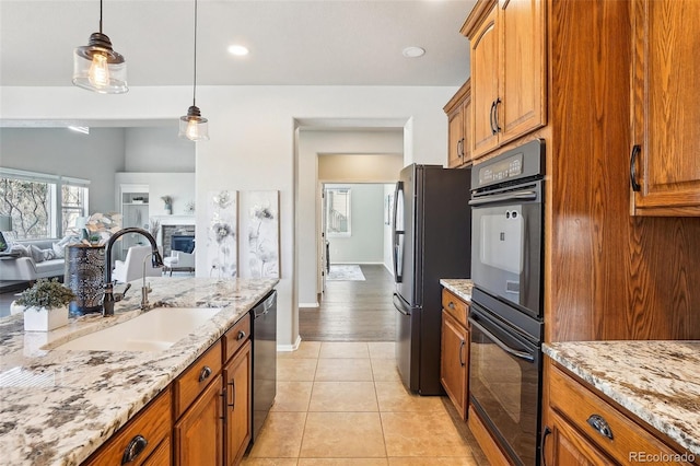 kitchen featuring sink, refrigerator, hanging light fixtures, light tile patterned floors, and stainless steel dishwasher