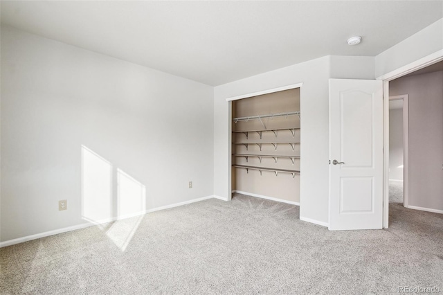 unfurnished bedroom featuring carpet flooring and a closet