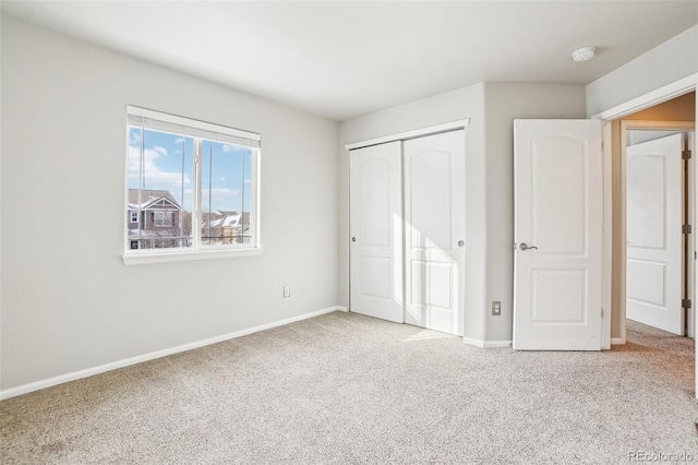 unfurnished bedroom with carpet and a closet