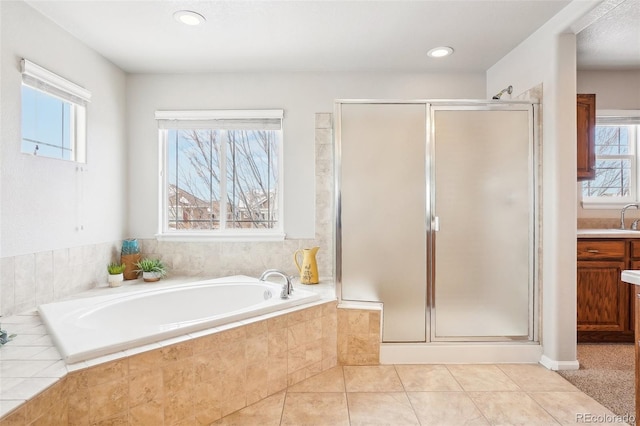 bathroom featuring a healthy amount of sunlight, vanity, independent shower and bath, and tile patterned flooring