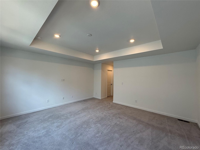 9041 Redfield Ln, Parker, CO 80134 - spare room with a tray ceiling, baseboards, carpet, and recessed lighting
