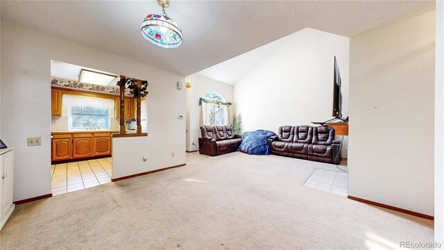 interior space with light carpet, lofted ceiling, and baseboards