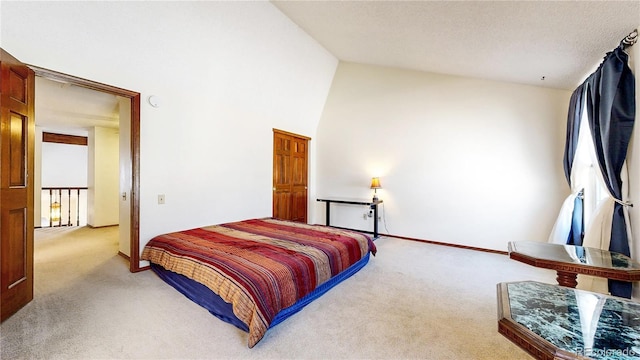 bedroom featuring high vaulted ceiling, carpet flooring, and baseboards